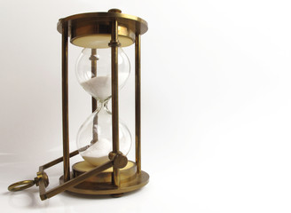 Vintage brass hourglass on white