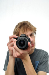 Young teenage boy holding Digital SLR Camera