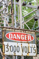 Danger sign in front of high voltage