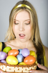 Fototapeta na wymiar Young sexy woman with lots of easter coloured eggs concept
