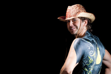 handsome cowboy with body art back isolated