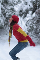 Young woman jumping on the snow