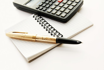 Note notepad in a cage, a pen pen and the countable machine