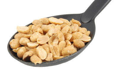 dry roasted peanuts on spoon isolated on white