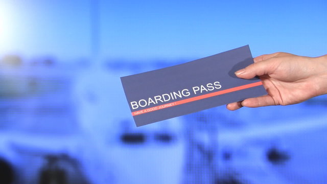 Hand Giving Boarding Pass On The Airport