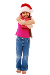 Girl squeezing her Christmas present tight isolated on white