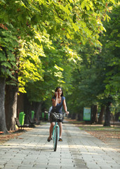 Fototapeta na wymiar Woman on the phone riding bicycle