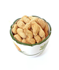 peanuts with shells on the plate isolated on white