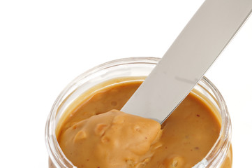 Knife and Chunky Peanut Butter in a Jar