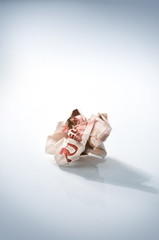 Single crumpled euro bill on floor