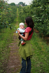 Mother carrying her baby in sling