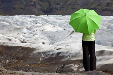 Environmental Concept Of A Woman With Green Umbrella By Glacier