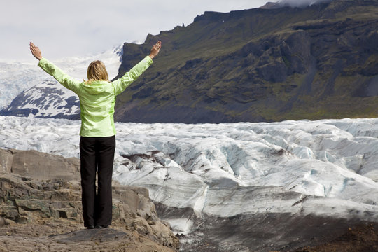Woman Hiker Celebrating Arms Raised By Vatnajokull Glacier Icela