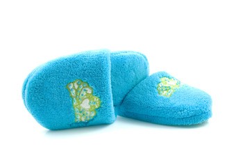 Pair of blue slippers for children over white background
