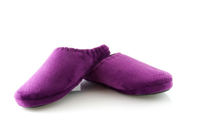 Pair of purple slippers over white background