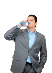 Businessman drinking water from plastic bottle