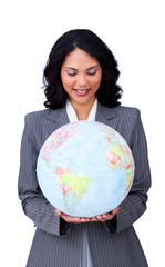 Confident ethnic businesswoman smiling at global business