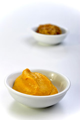 some organic mustard in a white bowl