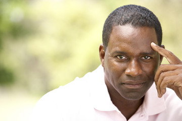 Obraz premium Portrait Of Young Man Sitting In Park