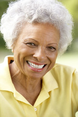 Fototapeta na wymiar Portrait Of Smiling Senior Woman Outdoors