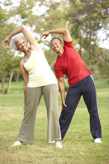Obraz premium Senior Couple Exercising In Park