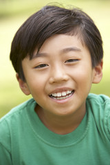 Portrait Of Young Boy In Park