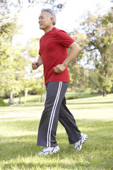 Senior Man Jogging In Park