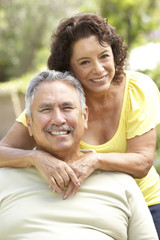 Obraz premium Senior Couple Relaxing In Garden Together