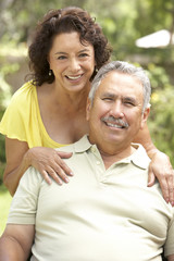 Obraz premium Senior Couple Relaxing In Garden Together