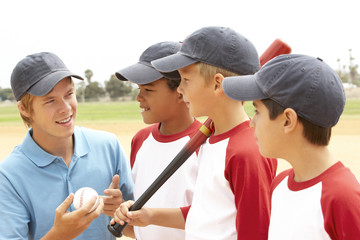 Young Boys In Baseball Team With Coach