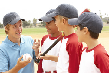 Young Boys In Baseball Team With Coach