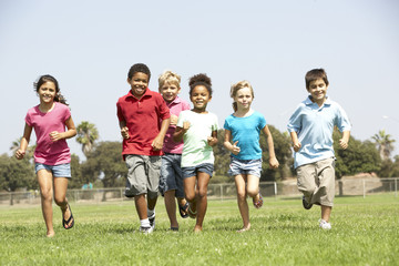 Obraz na płótnie Canvas Group Of Children Running In Park