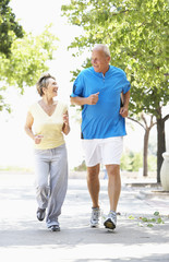 Fototapeta premium Senior Couple Jogging In Park