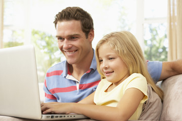 Fototapeta premium Father And Daughter Using Laptop At Home