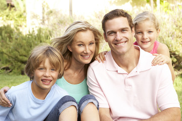 Fototapeta premium Young Family Relaxing In Garden Together