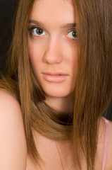 Naklejka premium The long-haired young modest beauty