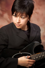 Multiethnic Girl Poses with Electric Guitar