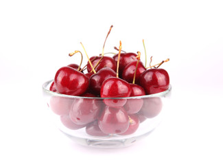 Fresh tasty cherries cherries on glass bowl over