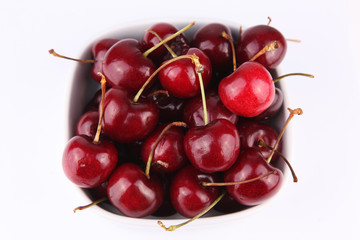 Obraz na płótnie Canvas Fresh tasty cherries over white background