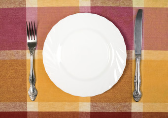 Plate with knife and fork on the table
