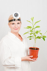 Young  female scientist of botany with green plant