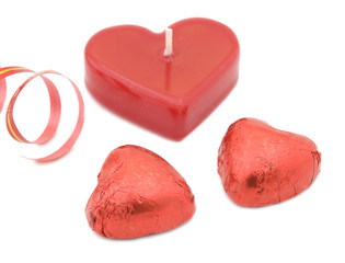 Chocolate hearts, candle and ribbon