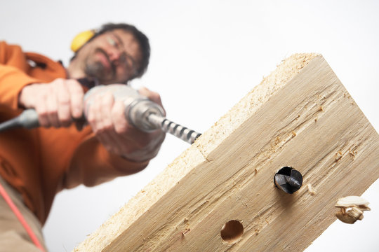drilling holes into a thick plank