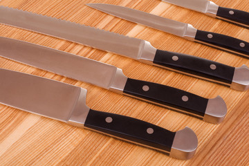 Set of kitchen knifes isolated on wooden background