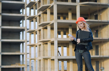 young girl in a helmet before building