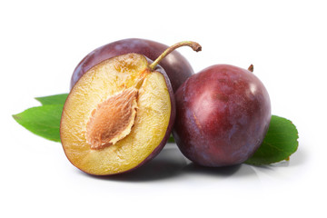 Plums and leaves on a white background.