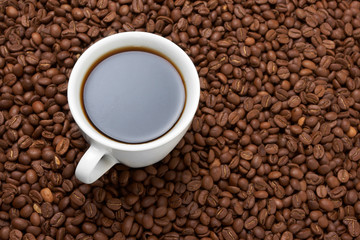 Cup with coffee, costing on coffee grain