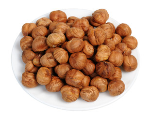 Hazelnuts on a white plate, isolated.