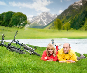 two cyclists on river bank