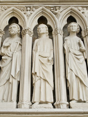 Holy man. Entrance of the XIII century church. France.